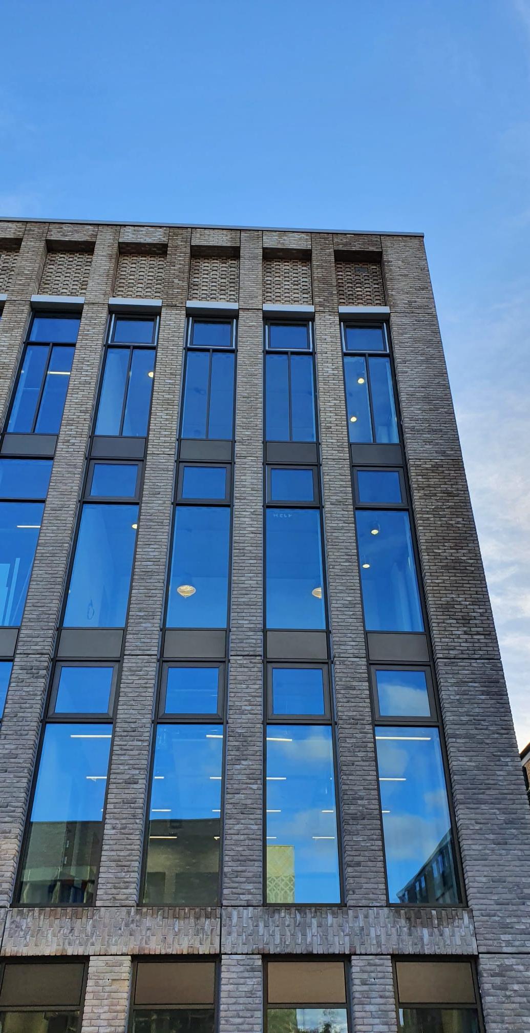 UOB Birmingham — University building envelope: stone cladding, glazing and green wall.